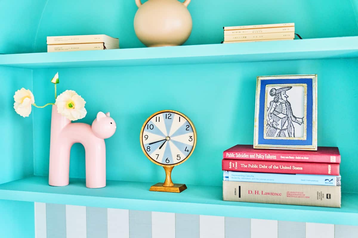 Shelf details with clock and pink cat