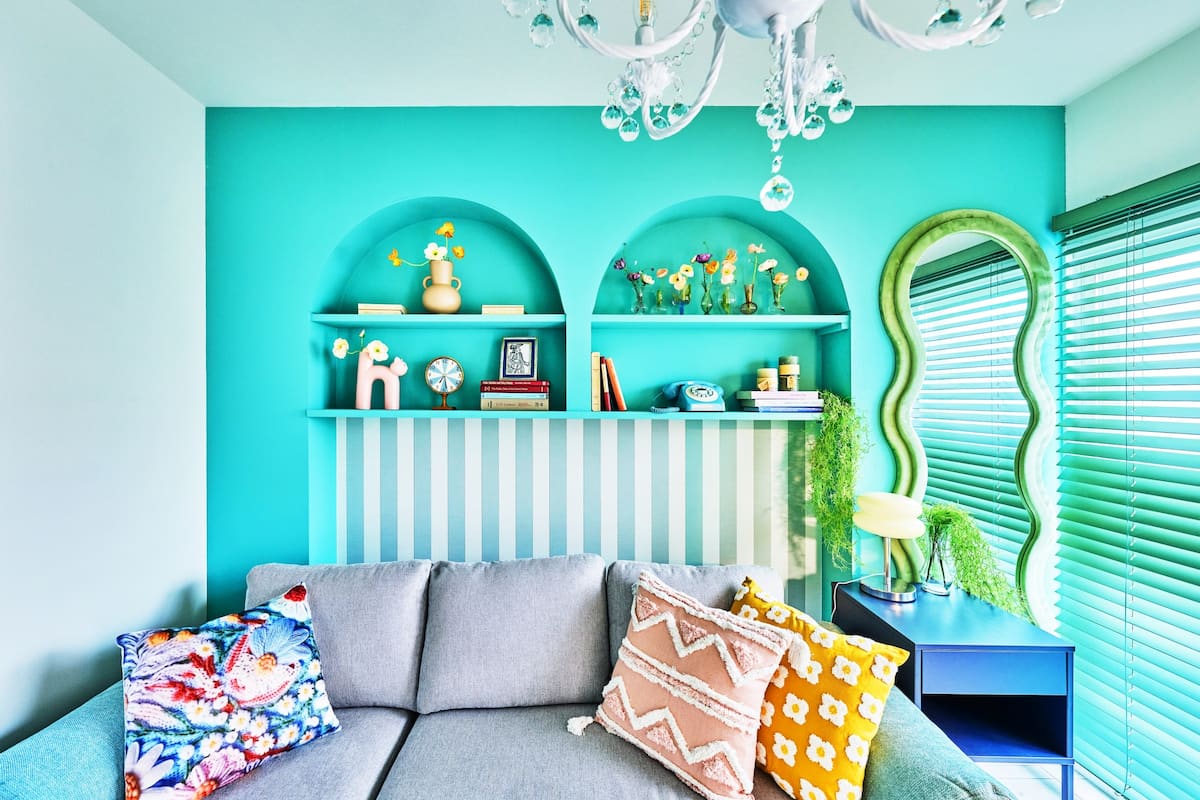 Tokyo Candy living room with turquoise arched shelves and gray sofa